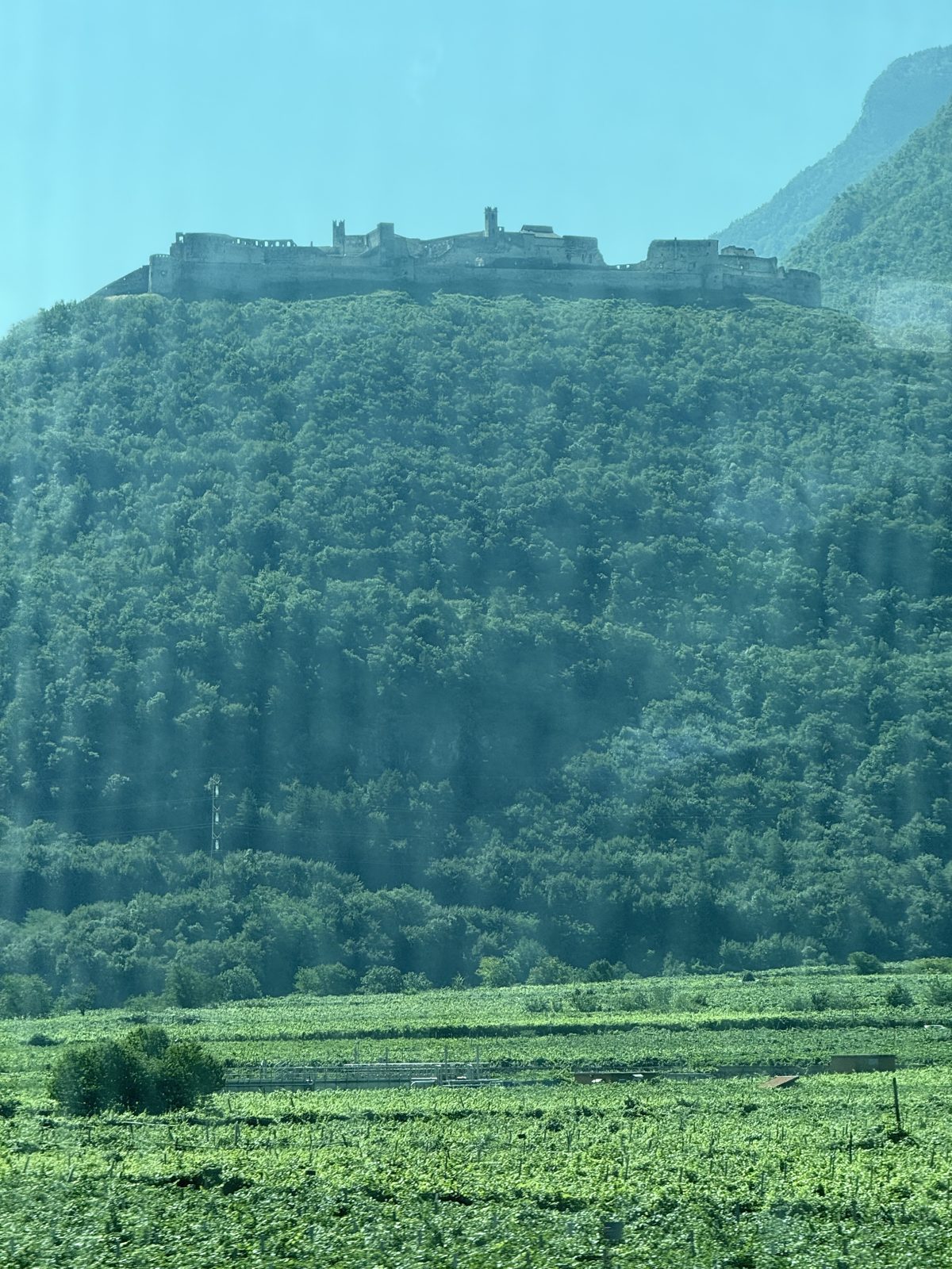 castles on the hills, seen from the train to Bolzano